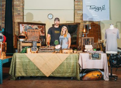 (L–R) Cade and Taelor Mangelson of Twigs Woodwear pose with their pop-up shop where they were selling their wooden watches and other nature-inspired accessories. Photo: @clancycoop