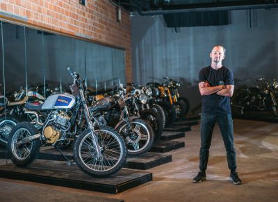 Salty Bike Revival co-founder Jason "Rev" Clark poses next to a row of bikes in the invited builder room. Photo: @clancycoop