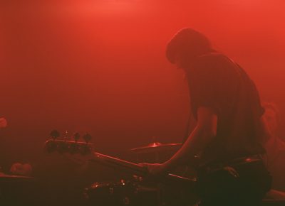 Bassist Emma Richardson emerging from the smoke. Photo: Logan Sorenson @Lmsorenson