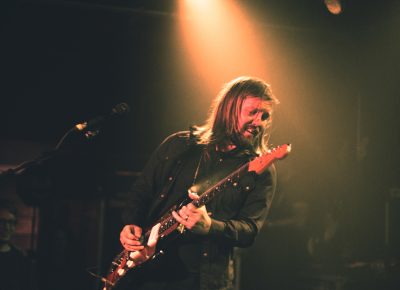 Guitarist Russell Marsden being bathed in stage lights as well as love from the audience members. Photo: Logan Sorenson @Lmsorenson