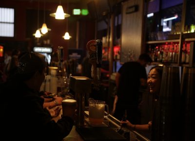 Beer and spirits being poured with a smile at In The Venue. Photo: @Lmsorenson