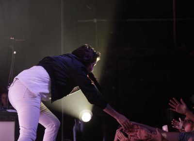 Tegan of Tegan and Sara jumps down to the crowd for a few fives. Photo: @Lmsorenson