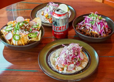 The bright colors and bold flavors of Blue Poblano’s Dang Quesadilla and Vegetarian Taco pair perfectly with a refreshing, ice-cold Tecate.