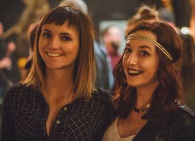 (L–R) Sara Day and Allison Shepard eagerly wait in line for their chance to sample a cocktail from the bar. Photo: Talyn Sherer