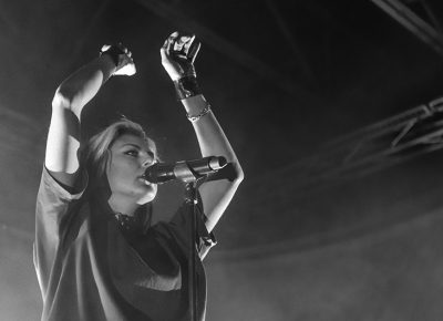 Sarah Barthel raises her hands above her head, joining the fans in clapping to the beat. Photo: ColtonMarsalaPhotography.com