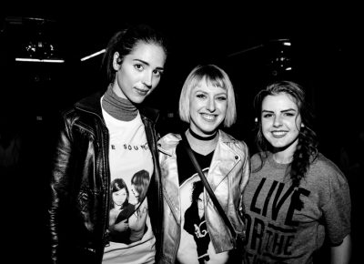 (L–R) Sandra, Jenica, and Katelyn wait near the merch booth for The Sounds to come on. Photo: Gilbert Cisneros