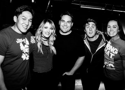 (L–R) Jared, McKenna, Sam, Jordan and Katie stand near The Sounds' merch table. Photo: Gilbert Cisneros