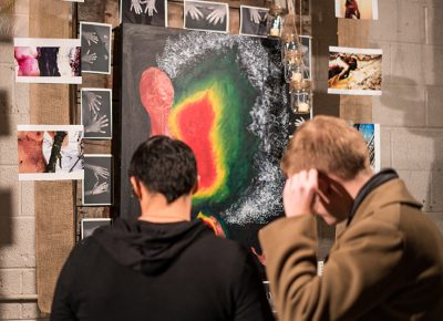 This fellow starts nervously fiddling with his ear while looking at Emily Senkosky’s installation, which incorporated photos of burned bodies. Photo: Jo Savage // @SavageDangerWolf