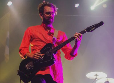 Jacob Tilley of Young the Giant slowly transitions into the magenta lights on stage. Photo: Talyn Sherer.