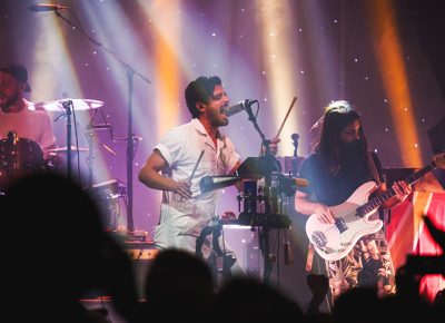 Young the Giant’s Sameer Gadhia moves to his own personal rig of noise, complete with a cowbell and all. Photo: Talyn Sherer.