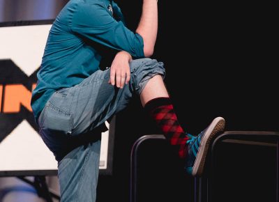 Host Chris Provost gives the audience a gratuitous view of his snazzy new socks. Photo: Lmsorenson.net