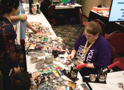 Kid Con! Small cosplayers are able to make their own buttons out of old comic books and other materials. Photo: Lmsorenson.net