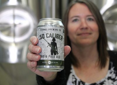 Vernal Brewing Co.'s Owner Ginger Bowden offers a sample of .50 Caliber, their India Pale Ale. Photo by Chris & Sylvia Hollands.