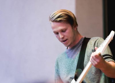 flor's bassist play onstage at the Gallivan Center. Photo: Logan Sorenson / Lmsorenson.net