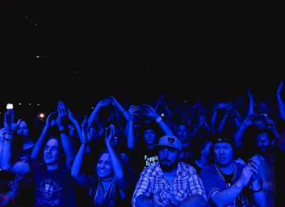 Fans of Flogging Molly being bathed in blue light during the set. Photo: Lmsorenson.net