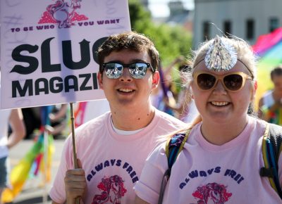 (L–R) Nathan Parker and SLUG Community Development Assistant Anne Olsen stand proud with Utah’s LGBTQ+ communities. Photo: John Barkiple