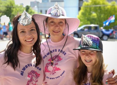 (L–R) Shelbey Lang, Meg Bohun and Teley sport silver unicorn horns to complement their "always free" unicorn shirts. Lang is Craft Lake City’s Artisan Coordinator. Photo: John Barkiple