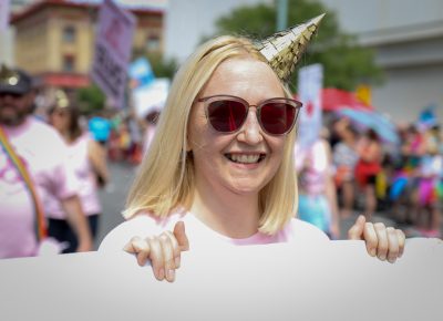 Craft Lake City Project Coordinator Mandy Williams carries the SLUG banner during the Pride Parade. Photo: John Barkiple