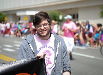 Nick Caurvina brought up the back of SLUG’s parade presence by carrying a final banner. Photo: John Barkiple