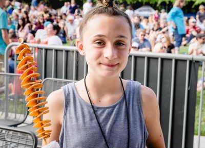 Emily scored a Spud on a Stick, one of the food vendors at this year's Ogden Twilight. Photo: Lmsorenson.net