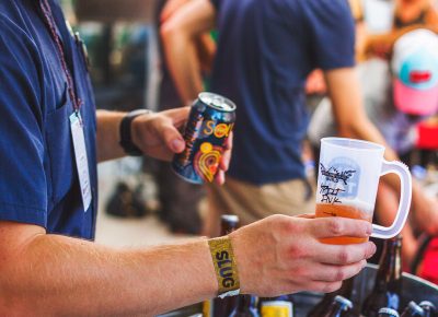 Epic Brewery pours up a sample of their Sour IPA as an eager fan awaits its refreshing powers. Photo: Talyn Sherer