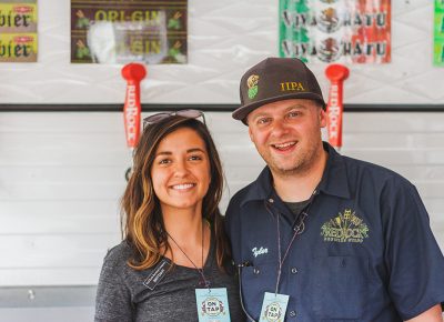 (L–R) Brittany Watts and Tyler Wright repped the Red Rock booth like the true pros that they are. Photo: Talyn Sherer
