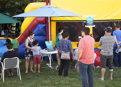 Parents watch their children playing in a bounce house. Photo: @jbunds