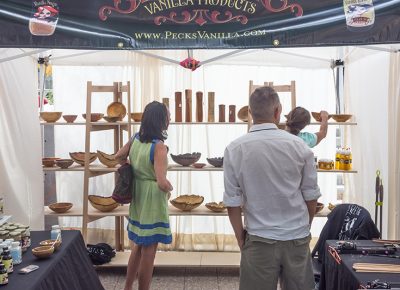 Festival attendees admire Alan Peck's works of art. Photo: @colton_marsala