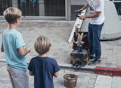 A puppeteer garners the attention of two boys. Photo: @william.h.cannon