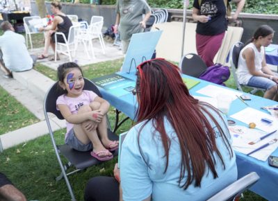 A child excited to have her face painted. Photo: @jaysonrossphoto