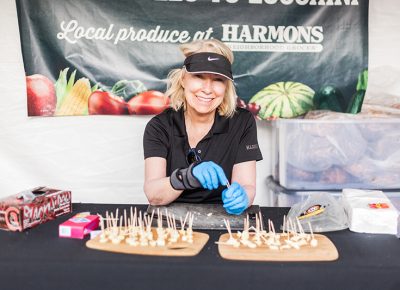 The lovely Leslie prepares some cheese samples at the Harmons tent. Photo: Chris Gariety