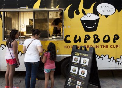 Three ladies order food from the Cup Bop truck. Photo: @jbunds