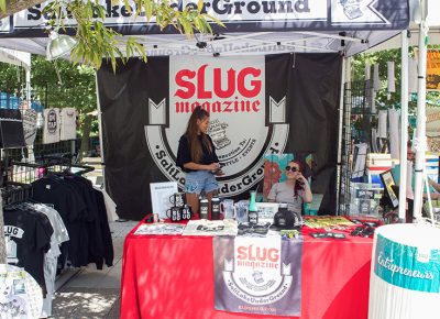 (L–R) Madi Mekkelson and Morgan Valentine volunteering at the SLUG Magazine booth, always smiling amid all their diligent work. @cezaryna