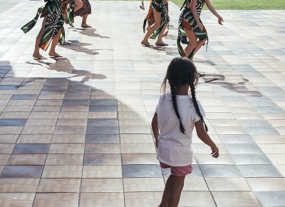 A girl enthralled by the dancers accompanying a drumming group. Photo: @william.h.cannon