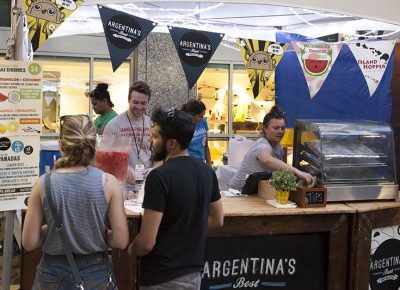 Two patrons look to Argentina's Best Empanadas for the goods featured on their menu. Photo: @jbunds