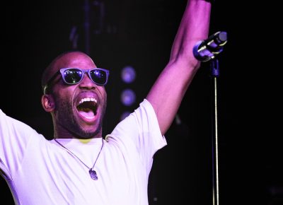 Trombone Shorty raising his instruments over his head as he greets the crowd. Photo: Lmsorenson.net