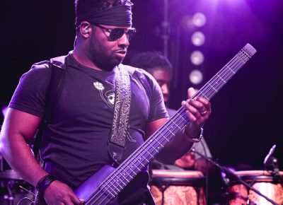 Mike Bass-Bailey playing bass guitar during the show at Red Butte Amphitheatre. Photo: Lmsorenson.net