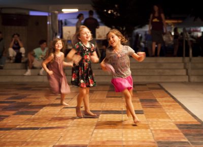 Three little girls chase each other before the band Joshy Soul and the Cool starts playing on the SLUG Mag Stage. Photo: @jbunds