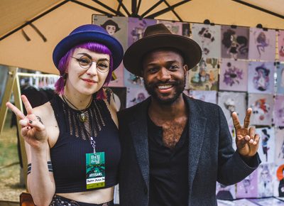 (L–R) Friends Heather Mahler and Joshua Strauther pose for a quick picture in front of Heather’s booth. Photo: @taylnshererphoto