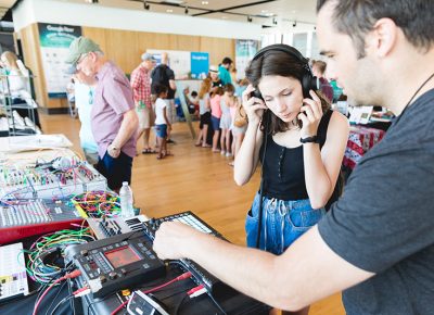 An instructor demonstrates the audio equipment on display in the STEM building. LmSorenson.net