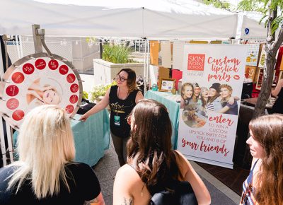 Craft Lake City DIY Festival visitors spin the wheel for a prize from Skinworks School of Advanced Skincare. LmSorenson.net