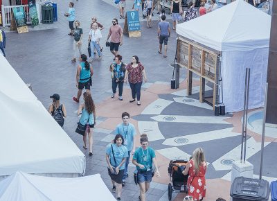 The crowd, staff and volunteers find the shady side of the festival for a break from the summer sun. Photo: @william.h.cannon