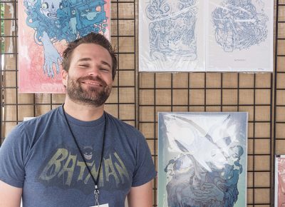 Chris Bodily poses in front of his artwork. Photo: @colton_marsala