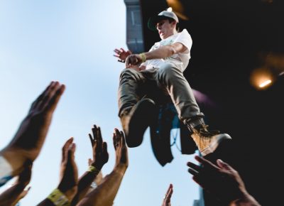 The fan soars over the crowd, jumping from the stage to the sea of hands below. Photo: Lmsorenson.net