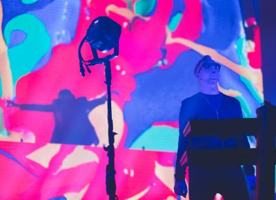 Andy Fletcher stands ready as the music swells and Dave Gahan stretches his arms on a platform at the back of the stage. Photo: Lmsorenson.net