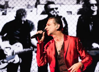 Dave Gahan sporting a red sparkling jacket on-stage at USANA. Photo: Lmsorenson.net