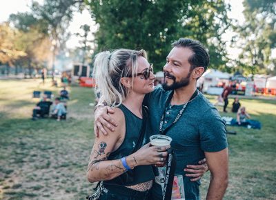 (L–R) Cardi and Aaron greeting each other with a hug. These two work for Uinta, who is a major sponsor for the Twilight Concert Series. Photo: johnnybetts.com