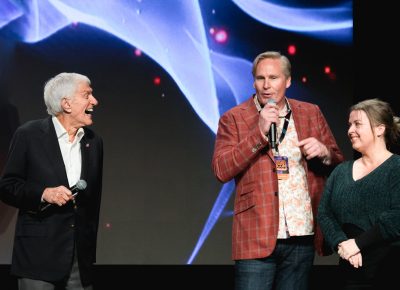 Comic Con heads Dan Farr and Bryan Brandenburg help Dick Van Dyke sing to his wife for her birthday. Photo: Lmsorenson.net