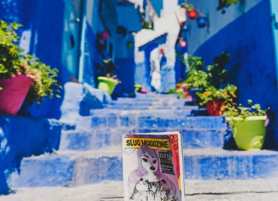 The infamous steps in the blue city of Chefchaouen finds a SLUG Magazine blending into its colorful display. Photo: Talyn Sherer