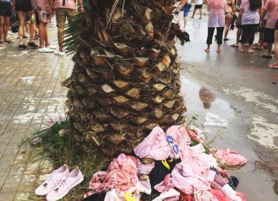 The customary stripping of clothes and accessories takes place as we wander through town looking for a local with a garden hose to shower us down. Photo: Talyn Sherer